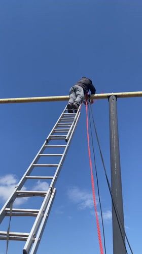 Man climbs ladder to reach elevated bar in Sarapul