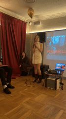 Woman delivers speech at Moscow event with projection screen