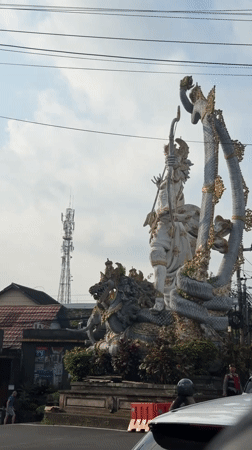 Ornate Hindu statue documented at Ubud street intersection
