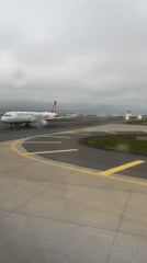 Rainy afternoon at Turkish airport captured from aircraft windows