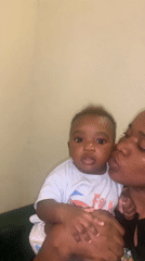 Woman kisses baby in tender moment in Nigeria