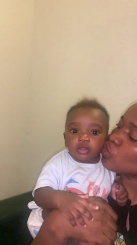 Woman kisses baby in tender moment in Nigeria