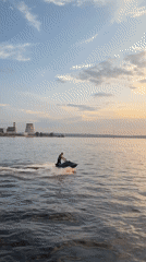 Jet skiing session on Izhevsk waterway with industrial backdrop