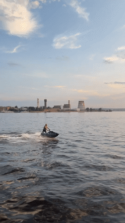 Jet skiing session on Izhevsk waterway with industrial backdrop