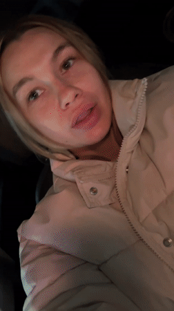 Woman sits in parked car at night in Voronezh