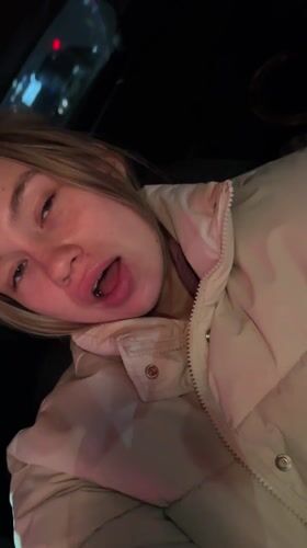 Woman sits in parked car at night in Voronezh