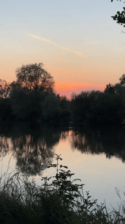 Sunset captured over tranquil lake in Veauchette, France
