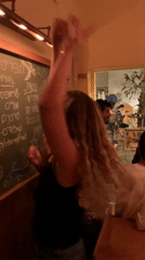 Women dance at busy Tel Aviv restaurant Tuesday evening