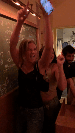 Women dance at busy Tel Aviv restaurant Tuesday evening
