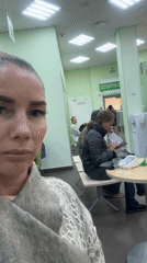 Woman films selfie video in Abakan waiting room