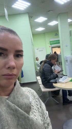Woman films selfie video in Abakan waiting room