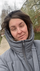 Woman takes morning selfies near mural in Noviy, Russia