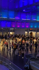 Group line dancing under colorful lights in Buenos Aires venue