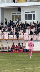 Soccer match underway at Da Lat stadium with spectators
