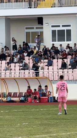 Soccer match underway at Da Lat stadium with spectators