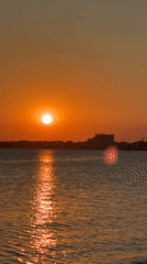 Sunset over Pomorie's coast, fishing boats and a resting seagull