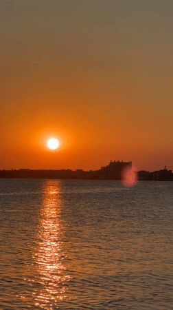 Sunset over Pomorie's coast, fishing boats and a resting seagull