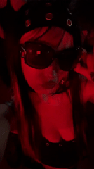 Young person photographed at red-lit Milan nightclub venue