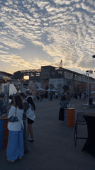 Outdoor gathering held in industrial Limassol space with construction backdrop