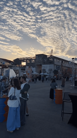 Outdoor gathering held in industrial Limassol space with construction backdrop