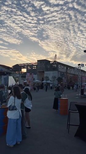 Outdoor gathering held in industrial Limassol space with construction backdrop