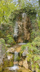 Moss-covered waterfall observed in Russian coastal town park