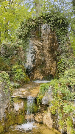 Moss-covered waterfall observed in Russian coastal town park