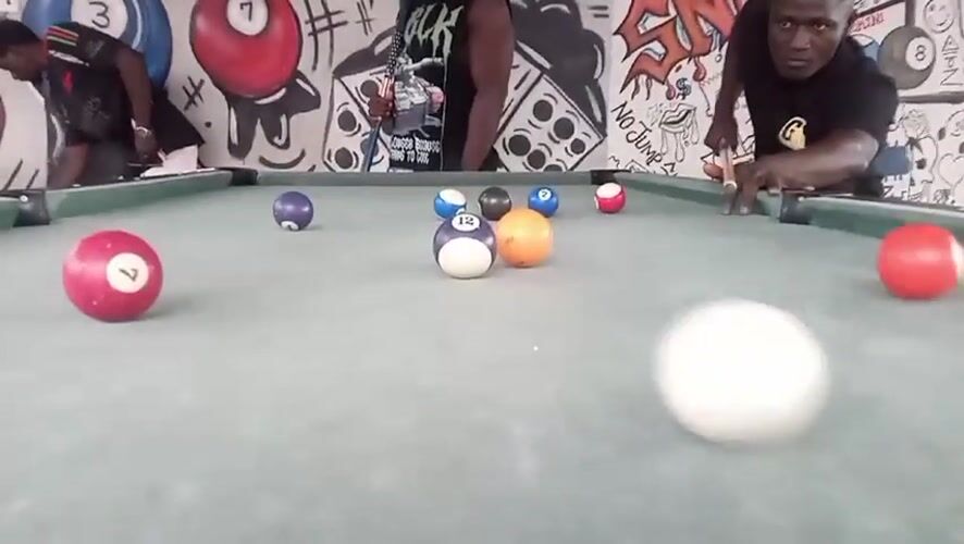 Men play pool in Akwanga, Nigeria