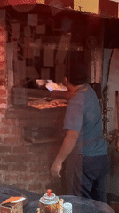 Street food vendor operates brick oven in Buenos Aires