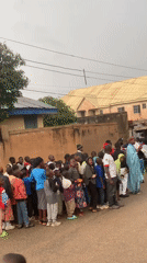 Street procession with drums and crowds in Jos, Nigeria