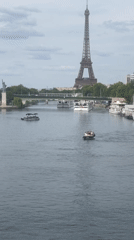 Seine River traffic with Eiffel Tower in the background