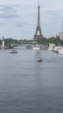 Seine River traffic with Eiffel Tower in the background