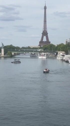 Seine River traffic with Eiffel Tower in the background