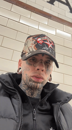 Tattooed person displays gin bottle in Buenos Aires