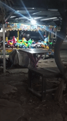 Setu street life at night: rides, stalls, and moonlight