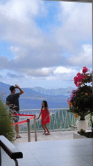 Father and daughter enjoy mountain views from Kintamani balcony