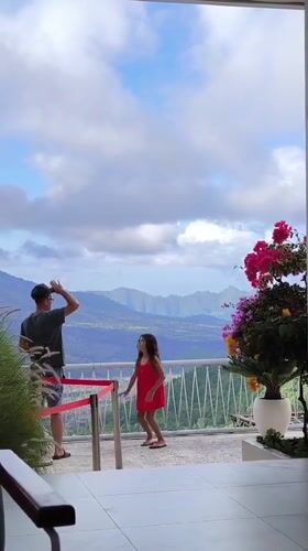 Father and daughter enjoy mountain views from Kintamani balcony