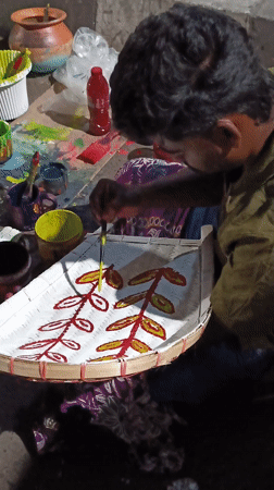 Street artisans hand-paint decorative bamboo crafts in Dhaka