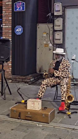 Saxophone player in leopard-print suit performs on Pyeongtaek streets at night
