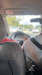 Driver photographed in parked Mazda on Abuja street