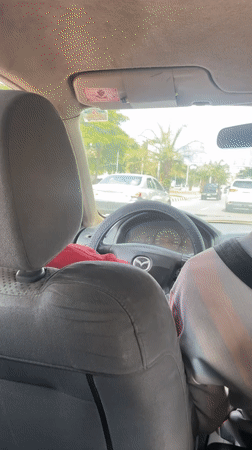 Driver photographed in parked Mazda on Abuja street