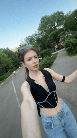 Woman films selfie content while rollerblading in Moscow park