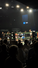 Boxing match with headgear-wearing fighters draws crowd at arena