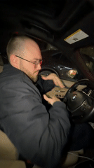 Driver enjoys music in BMW during rainy Tbilisi evening