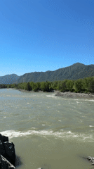 Milky green river flows through mountain landscape near Elekmonar