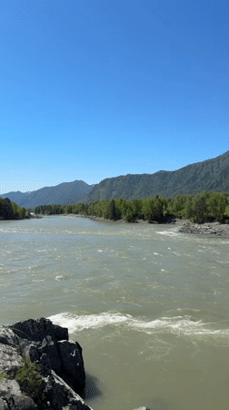 Milky green river flows through mountain landscape near Elekmonar