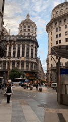 Evening street activity captured near ornate buildings in Buenos Aires