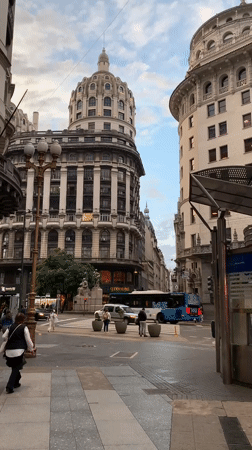 Evening street activity captured near ornate buildings in Buenos Aires