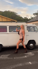 Young adults socialize with drinks near van in Thirroul
