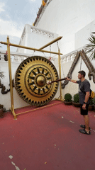 Tourists ring ceremonial gong at Bangkok's Giant Swing shrine